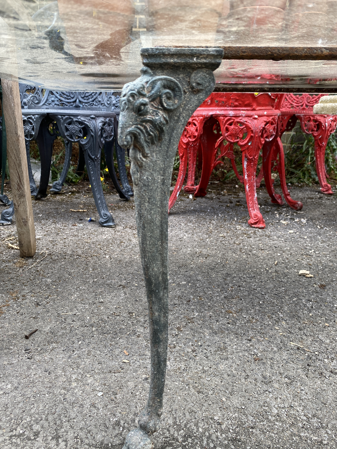 A square glass top cast metal garden table on a metal base, length 100cm, height 44cm together with a pair of teak elbow chairs